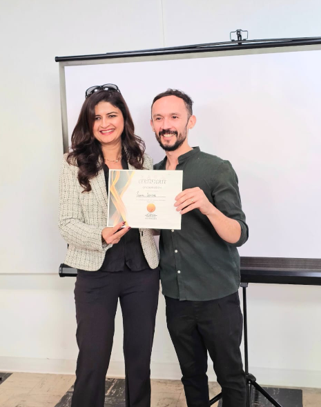 Sona holding her hair system training certificate